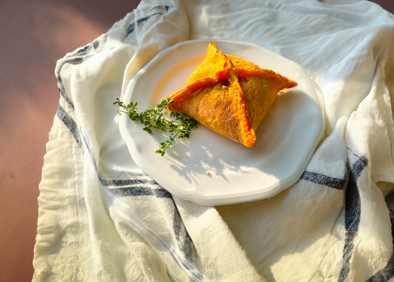 A plated Propa Patty, hand-folded and golden